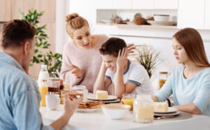 Family at the breakfast table having an argument