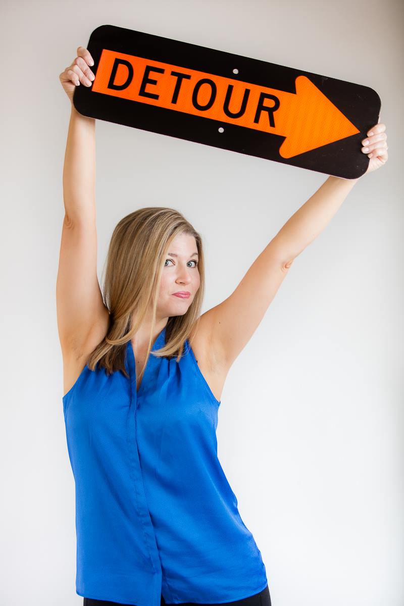 Resilience keynote speaker Courtney Clark holding Detour sign